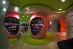 the interior of a book store with pink and green accents