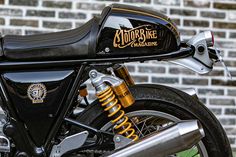 a motorcycle parked next to a brick wall