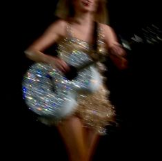 a woman in a short dress holding a frisbee