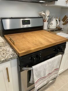 an oven with a cutting board on top of it