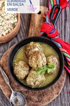 meatballs and rice in a bowl on a wooden board