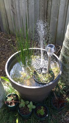 a water fountain in a potted planter