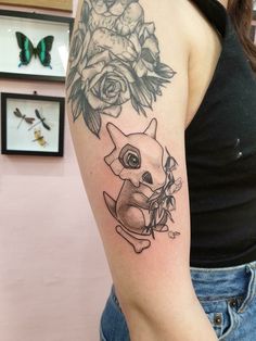 a woman with a tattoo on her arm has a flower and a small dog in it