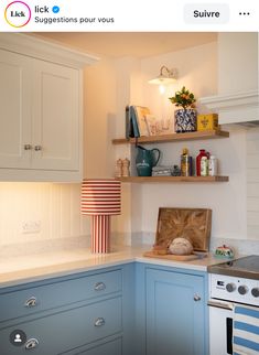 an image of a kitchen setting with blue cabinets