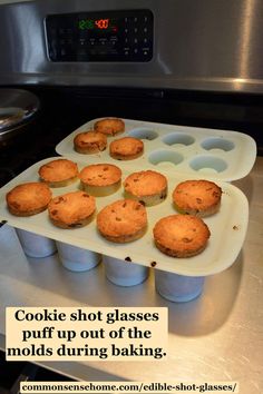 some muffins are sitting on a tray in front of an oven with the words cookie shot glasses puff up out of the molds during baking