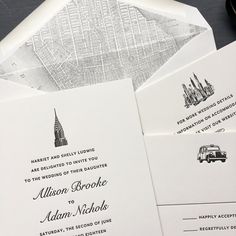 the wedding stationery is laid out on top of each other, including two envelopes