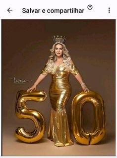 a woman in a gold dress and crown standing next to the number 50