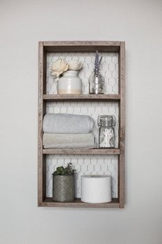 a bathroom shelf filled with toilet paper and other items