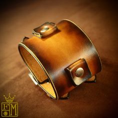 "This sunburst tan Leather cuff bracelet is 2.25\" wide cuff is custom hand dyed . It features two 3/4\" watch connectors and uses two straps/ buckles. The edges are perfectly slicked and sealed and Two top quality stainless steel buckles provide the closure A great width for any wrist! This cuff is inspired by the early Johnny Depp cuffs. can be used with or without a watch! Custom sized for your wrist! Use the instructions in the pics above! - 2.25\" wide - Fine vegetable tanned leather - Vint Vintage Brown Bracelet With Strap, Vintage Brown Bracelets With Bracelet Strap, Vintage Leather Festival Bracelets, Vintage Adjustable Distressed Brown Bracelets, Vintage Distressed Brown Leather Bracelet, Vintage Leather Bracelets With Patina, Vintage Gold Leather Bracelet, Vintage Brown Leather Bracelets, Adjustable Brown Cuff Bracelet With Patina