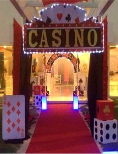 a red carpeted walkway leading to a casino entrance with dice and cards on it