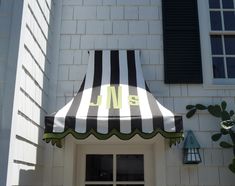 a black and white striped awning on the side of a building