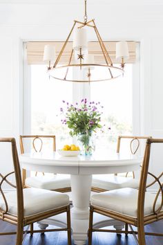 a white table with four chairs around it