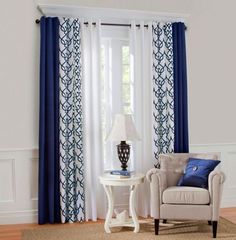 a living room with white walls and blue curtains