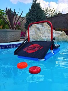 an inflatable pool with three frisbees and a net on it