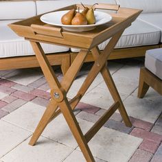 two pears sit on a tray in front of a white couch and coffee table