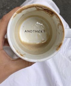 a person holding a coffee cup with the word another written on it