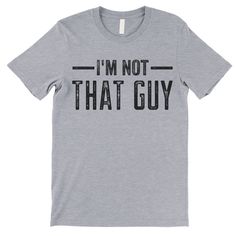 I'm Not That Guy short-sleeve crewneck t-shirt. Unisex Fit. Printed with eco-friendly water-based inks. Please refer to the size chart in the last image of the listing (laying flat measurements in inches). Due to the calibration differences between computer monitors, phone screens and tablets, the actual product color may vary slightly from what you are viewing. SHIRT FEATURES: - 4.2 oz., Solid color tees (red, white, blue, green) are 100% combed and ringspun cotton, 30 singles - Athletic Heathe Gray Graphic Tee With Funny Text, Unisex Gray Short Sleeve T-shirt, Gray Letter Print T-shirt, Funny Nerd, Gay Pride Shirts, Gay Humor, Pride Outfit, Phone Screens, Charcoal Color