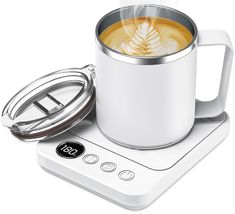 a cup of coffee sitting on top of a scale next to a glass container with a lid