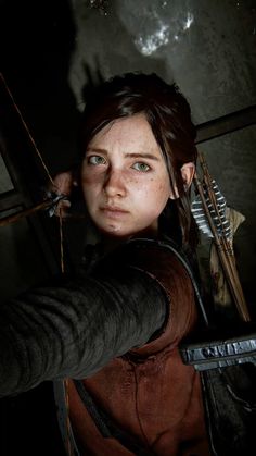 an image of a woman holding a bow and arrow in front of her face, looking at the camera