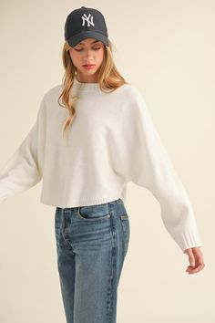 Crafted from cozy knit fabric, this cropped sweater boasts a relaxed and stylish look with its round neck and dolman sleeves. The comfortable and loose fit of the dolman sleeves add to its effortless chic styling, making it a versatile piece that can be paired with different bottoms for various outfits. Perfect for cooler weather, this sweater will keep you warm and fashionable all season long. Material composition: 100% acrylic Product measurements: S:Bust 33-35 in, Waist 25-27 in M:Bust 35-38 Denim Short Dresses, Cape Style, Style Sweater, Cozy Knit, Denim Leggings, Effortless Chic, Cozy Knits, New Tops, Sweater And Shorts