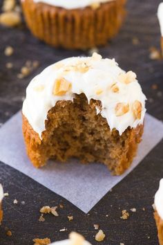 a cupcake with white frosting and nuts on top