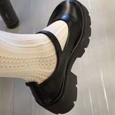 a person wearing black shoes and white socks