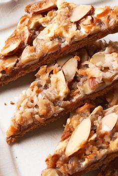 several pieces of food on a plate with almonds and other things in the background