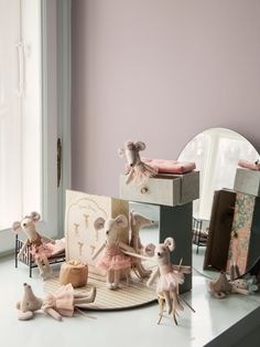 a group of figurines sitting on top of a table next to a mirror