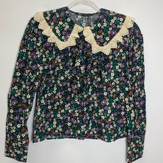 Size M Pit To Pit 19 Inch Nwt Zara Floral Printed Blouse With Ruffle And Lace Trim Adorable Floral Printed Blouse With Lace Trim Peter Pan Collar And Tie At Neck. Long Sleeves.Embroidery Cottagecore Cute Vintage Vibes 70s 90s 80s Preppy Work Office Floral Print Tops With Peter Pan Collar For Daywear, Fitted Floral Print Top With Peter Pan Collar, Zara Fitted Blouse With Collar, Zara Fitted Top With Collar, Zara Fitted Collar Top, Fitted Zara Collared Tops, Fall Tops With Lace Trim And Ruffled Collar, Zara Floral Print Collared Blouse, Zara Collared Blouse With Floral Print