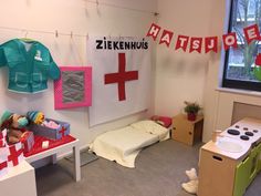 a child's hospital room with toys and medical supplies on the wall, including an infant crib