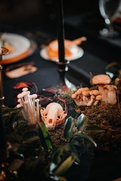 the table is set with mushrooms and candles