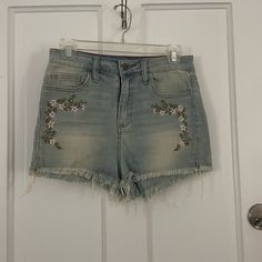 Embroidered Shorts With A Raw Hem. Never Worn. Casual High Waist Jeans With Floral Embroidery, Embroidered Denim Blue Jean Shorts, Embroidered Medium Wash Denim Jean Shorts, Trendy Embroidered Mid-rise Bottoms, Embroidered High Rise Blue Bottoms, Trendy Floral Embroidered Denim Blue Bottoms, Trendy Denim Blue Bottoms With Floral Embroidery, Casual Embroidered Cutoff Shorts, Light Wash Cotton Jeans With Floral Embroidery