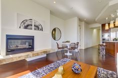 a living room filled with furniture and a fire place in the middle of a kitchen