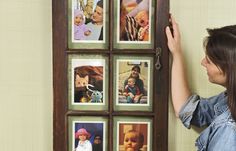 a woman hanging pictures on the wall with her hands