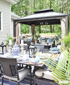 an outdoor dining area with chairs, table and umbrella