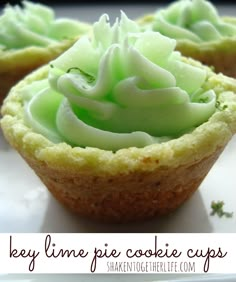 three cupcakes with green frosting sitting on a plate