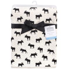 a black and white moose print baby blanket with a bow on it's head