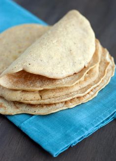 a stack of tortillas sitting on top of a blue napkin