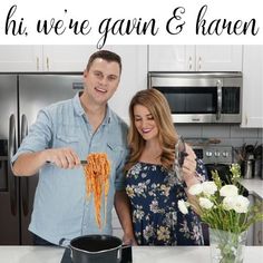 a man and woman standing in front of a kitchen counter with spaghetti on the stove