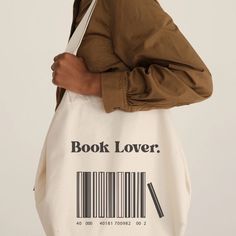 Discover our 'Booklover barcode' Tote Bag and celebrate your passion for reading in a personalized and unique way. Imagine a bag that perfectly sums up the happiness that books bring to your life. Our 'Booklover barcode' Tote Bag is much more than just a bag, it's a personalized work of art that showcases your personal library. On this tote bag, you can personalize the illustration with the names of your favorite books. Whether you're going to the library, the bookstore, the park, or work, our b