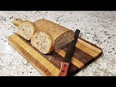 two slices of bread on a cutting board with a knife