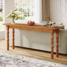 a wooden table sitting on top of a couch in a living room next to a window