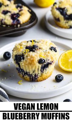 blueberry lemon muffins on a white plate next to some lemon wedges