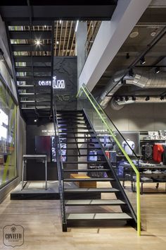 the inside of a retail store with stairs