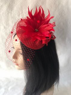 Red feather flower mini fascinator hat with dotted veil perfect for Kentucky Derby, hat for races, Tea party hat, Wedding hat, Mother of the bride hat, cocktail dinner, or any other special occasion. *Easy to wear *Lightweight *Worn on either side This is a fiery red sinamay fascinator free-formed with handmade feather flower and adorned and adorned with chenille dot to give a vintage appeal. Love what you see would like a different color? Please feel free to send a message we'd love to create a Summer Party Mini Hats Made Of Tulle, Summer Party Mini Tulle Hats, Tulle Hat For Kentucky Derby Party, Elegant Mini Tulle Hats For Party, Elegant Tulle Mini Hat For Party, Tulle Hat For Weddings And Kentucky Derby, Elegant Mini Hats With Feathers For Gifts, Elegant Mini Hats With Feathers As Gifts, Elegant Mini Hat With Feathers For Gift