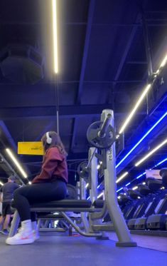 a person sitting on a bench in a gym