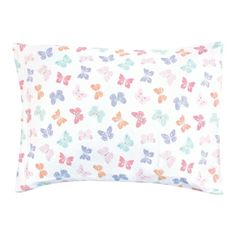 a white pillow with multicolored butterflies on the front and back of it, against a white background