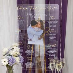 the wedding program is displayed in front of two champagne glasses and a vase with flowers