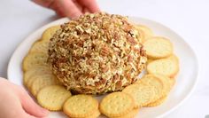 a plate with crackers and a cheese ball on it