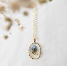 a necklace with a blue flower in it